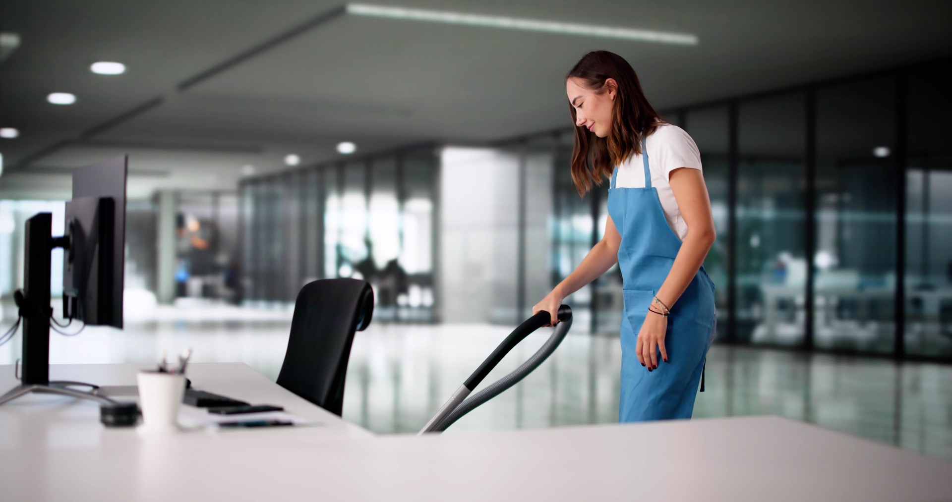 Professional Cleaner: Woman Maintains Sparkling Workspace